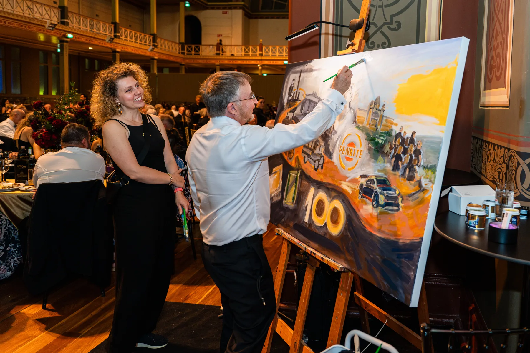A guest adding a brushstroke to the Penrite centenary painting with Olga