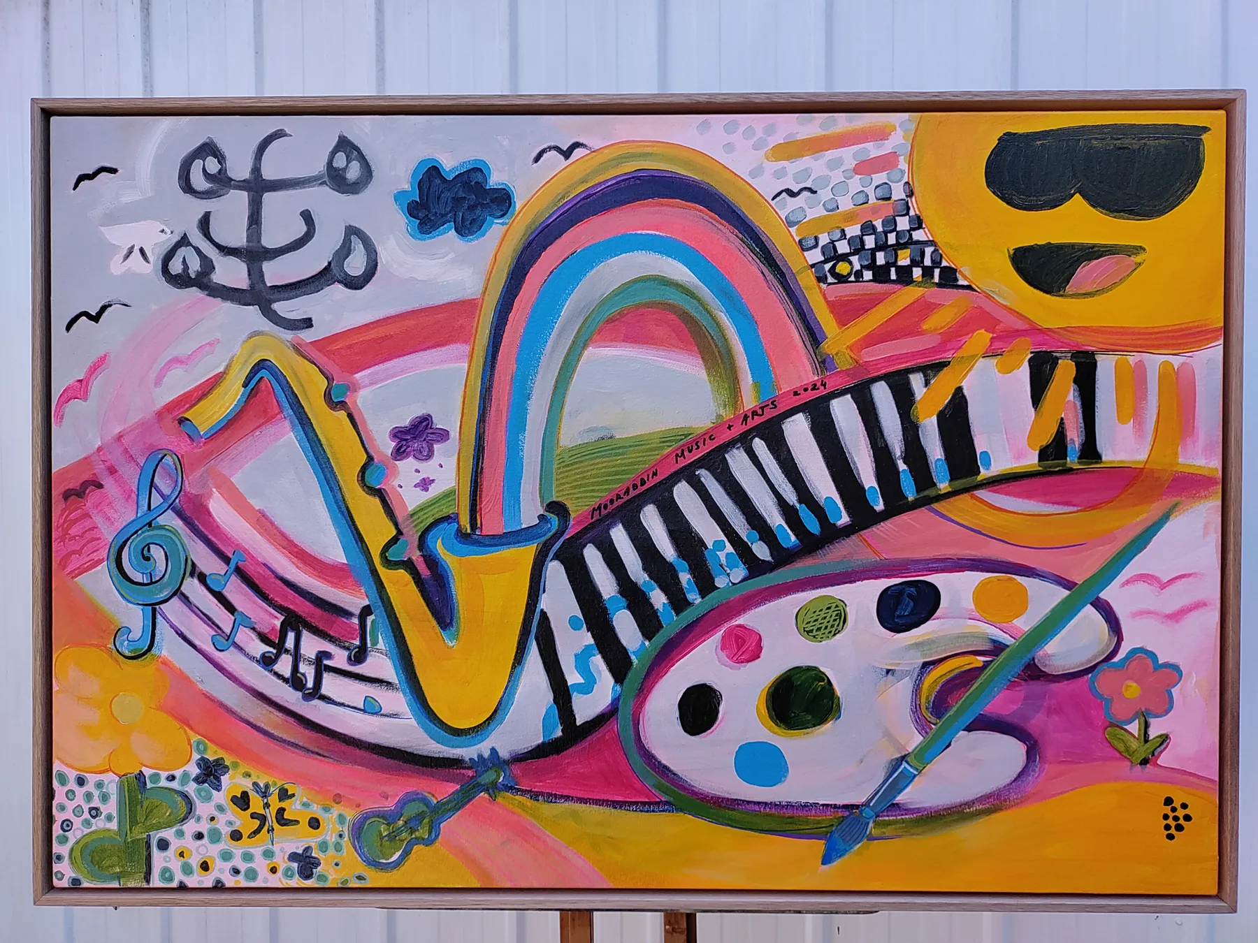 Painting of musical notes, piano keys, a rainbow and an artist’s palette